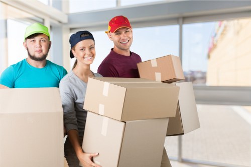 Moving team handling apartment furniture in a Docklands residential tower