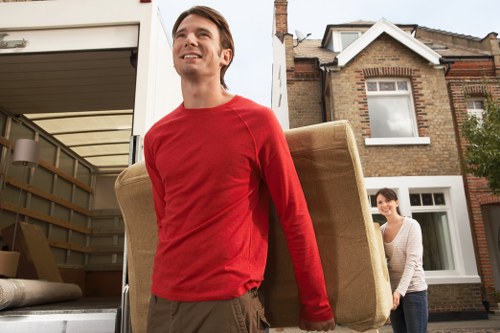 Local movers transporting boxes and home contents in a Docklands street